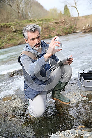 Biologist testing water quality of river Stock Photo