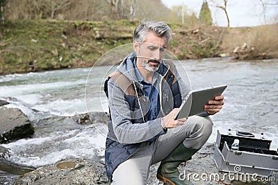 Biologist testing water quality of river Stock Photo