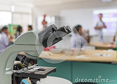 Biology or chemistry science class study with microscope and blur background of school student group learning in blurry lab Stock Photo