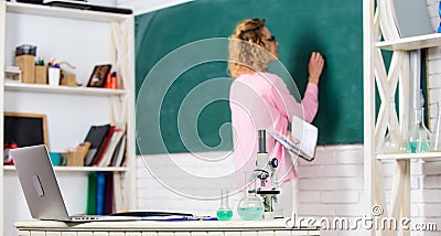 Biology laboratory. Student writing chalkboard defocused. Biology concept. Microbiology and bioengineering. Microscope Stock Photo