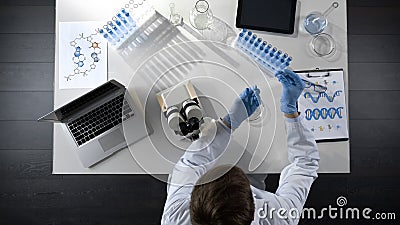 Biology student working with microscope, preparing sample to study, top view Stock Photo