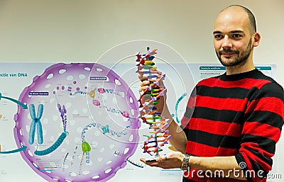 Biology teacher showing DNA model Stock Photo