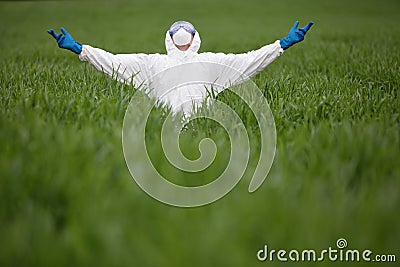 Biotechnology engineer raising arms on gmo field Stock Photo