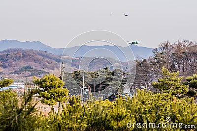 Biplane flying over mountainous region Editorial Stock Photo