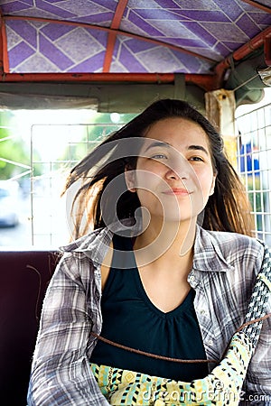 Teen girl riding tuktuk taxi in Cambodia Stock Photo