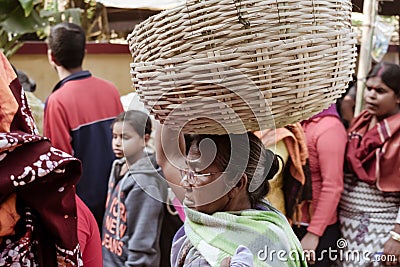 Birbhum district, Bolpur, West Bengal, India 1 May 2018 â€“ An old Active senior Bengali market vendor carrying a Basket on her Editorial Stock Photo