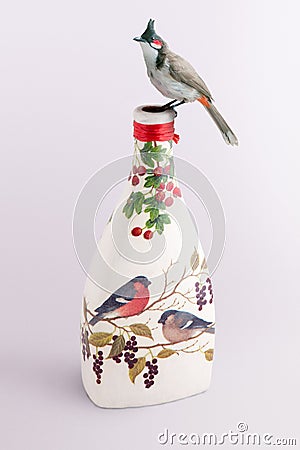 Bird on a decoupage bottle Stock Photo