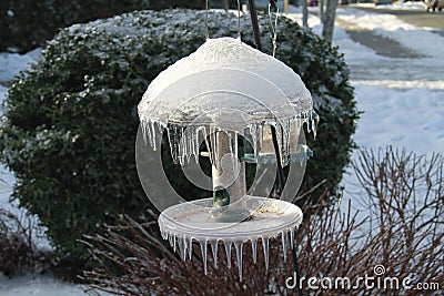 A bird feeder coated in ice Stock Photo