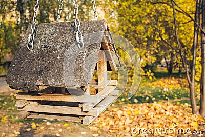 Bird feeders. Classic forest bird and squirrel feeder as small gabled house on tree Stock Photo