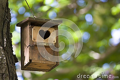 Bird house with the heart shapped entrance. Stock Photo