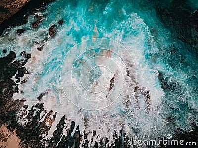 Bird`s eye view of the broken beach in Nusa Penida, Indonesia. Waves and foam, abstract background, drone photography Stock Photo