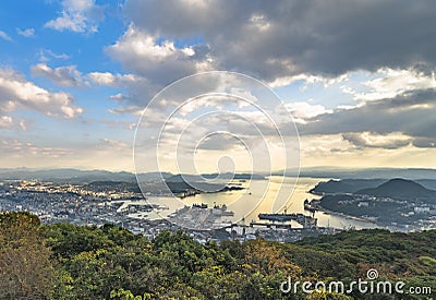 Bird`s-eye view of the Sasebo shipyard with the Kujukushima islands off coasts in background at sunset. Stock Photo