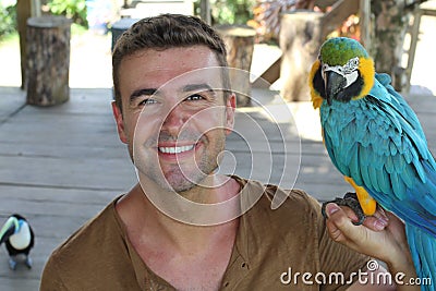 Bird tamer working with a macaw Stock Photo