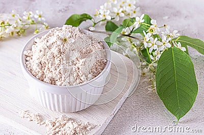 Birdcherry flour in a bowl, on light grey background Stock Photo