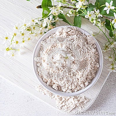 Birdcherry flour in a bowl, top view on grey background Stock Photo