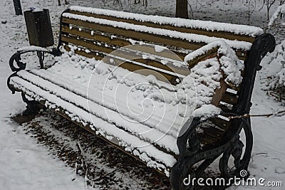 A birdhouse on a bench covered with fresh snow after weather phenomena Stock Photo