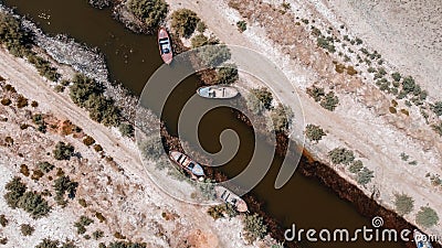 birds eye close drone shoot from a connection of lake - there is wooden boat over there red color is dominant Stock Photo