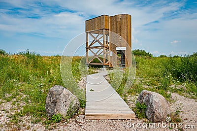 Birdwatching tower. Wooden observation tower against the blue sky. Stock Photo