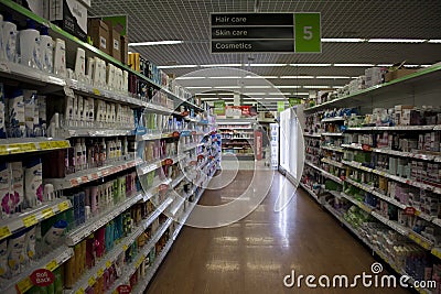 BIRMINGHAM, UK - March 2018 ASDA Aisle of Toiletries in Supermarket. Red Sale Tags on Selected Items. Glossy Floor Editorial Stock Photo
