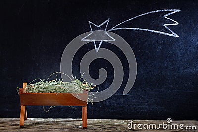 Birth of Jesus with manger and star on blackboard Stock Photo