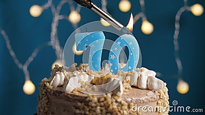 Birthday cake with 70 number candle on blue backgraund. Candles are set on fire Stock Photo