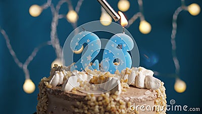 Birthday cake with 26 number candle on blue backgraund. Candles are set on fire Stock Photo