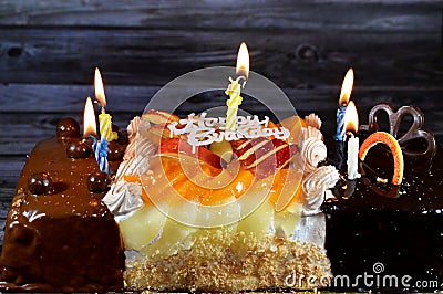 Birthday cake of three different pieces spongy creamy cake for celebrations, hazelnut chocolate spread, dark chocolate, caramel, Stock Photo