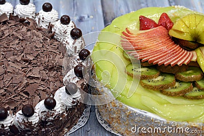 Birthday cakes of chocolate cake topped and surrounded by shredded chocolate thin layers and whipped cream topped with chocolate Stock Photo