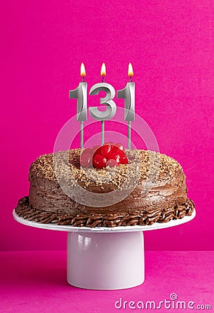 Number 131 candle - Chocolate cake on pink background Stock Photo