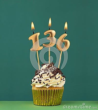 Birthday candle number 136 - Vertical anniversary card with green background Stock Photo