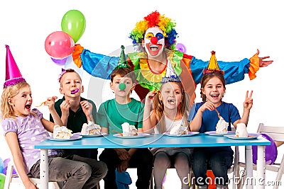 Birthday child clown playing with children. Kid holiday cakes celebratory. Stock Photo