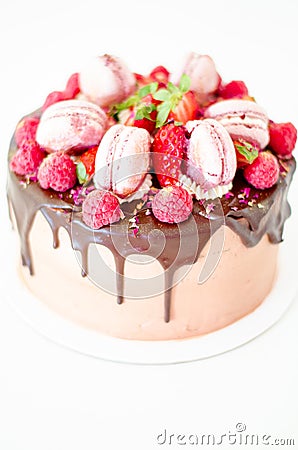 Birthday chocolate cake with strawberries, raspberries and macarons Stock Photo