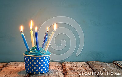 Birthday concept with cupcake and candles on wooden table. Stock Photo