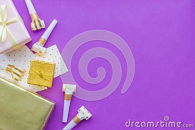 Birthday concept with gifts, greeting cards and party whistles on violet background top view copyspace Stock Photo
