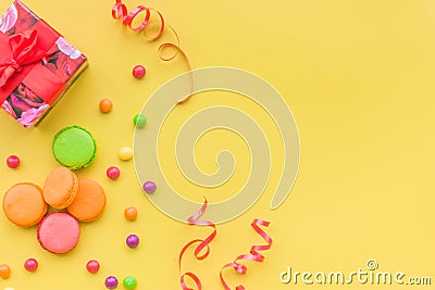 Birthday concept with wrapped gift and sweets on yellow background top view copyspace Stock Photo