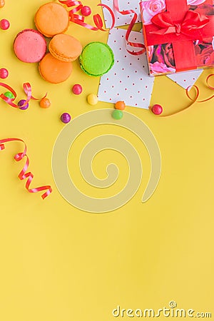 Birthday concept with wrapped gift and sweets on yellow background top view copyspace Stock Photo