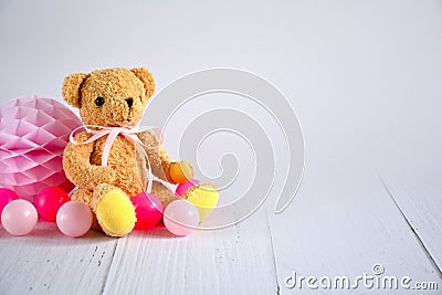 Birthday girl background with teddy bear with pink ribbon , pink small balls and honeycomb ball , space for text Stock Photo