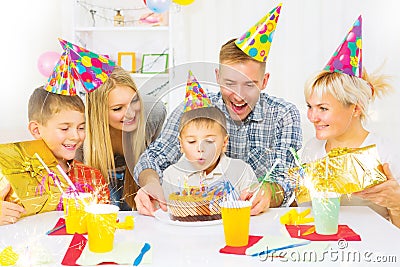 Birthday. Little boy blows out candles on birthday cake Stock Photo