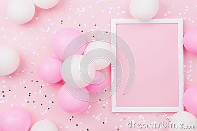 Birthday mockup with frame, pastel balloons and confetti on pink table top view. Flat lay composition. Stock Photo