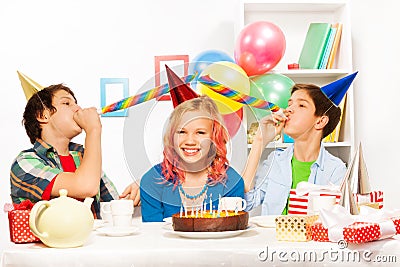Birthday party with boys blow noisemaker horns Stock Photo