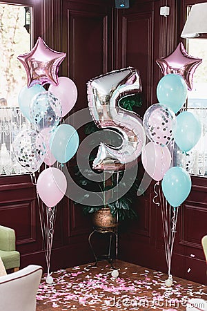 Birthday party decorations indoor with baloons of differen shapes Stock Photo