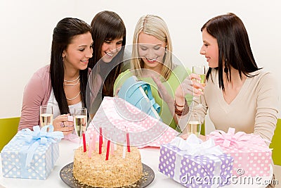 Birthday party - woman unwrap present, celebrating Stock Photo