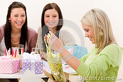 Birthday party - woman unwrap present, celebrating Stock Photo