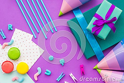 Birthday wrapped gifts and party hats on purple background top view Stock Photo