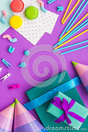 Birthday wrapped gifts and party hats on purple background top view copyspace Stock Photo