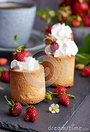 Biscuit cakes filled with wrapped cream and strawberries Stock Photo