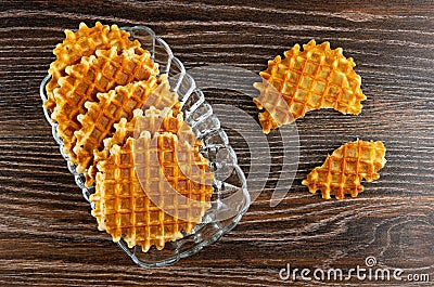 Biscuit wafers in transparent plate, broken wafer on wooden table. Top view Stock Photo