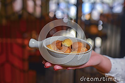 Biscuits with condensed milk in a white plate, closeup. Waiter serves nut cookies with condensed milk. Eating out Stock Photo