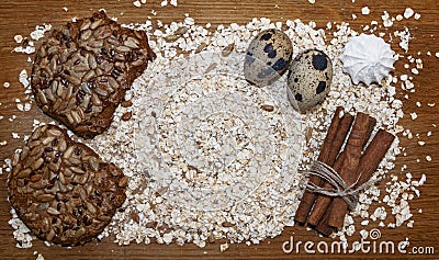 Biscuits, oats flakes, cinnamon sticks, meringue, eggs on a tab Stock Photo