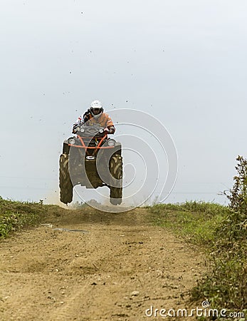 Man during a jump training while riding a quad. Editorial Stock Photo